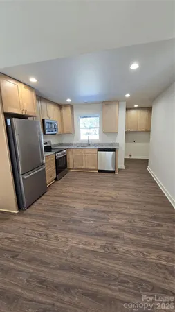 a large kitchen with a refrigerator a sink dishwasher and a stove
