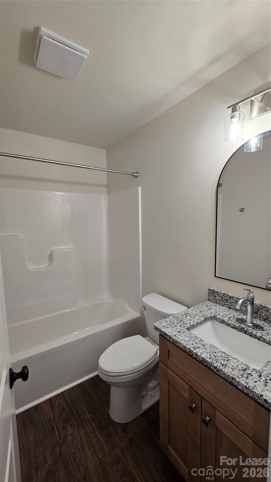 2326 Beth Haven Denver, NC 28037 - Photo 7 of 11 a bathroom with a granite countertop toilet a sink and a bathtub