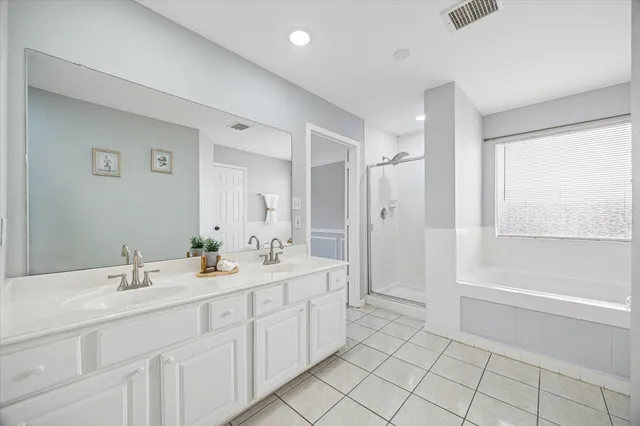 a spacious bathroom with a shower a sink and a mirror
