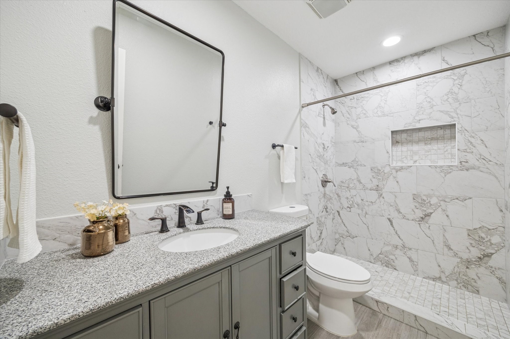 3414 Sapling Oak Drive Houston, TX 77082 - Photo 9 of 12 a bathroom with a granite countertop sink a toilet and a shower