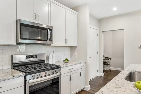 a kitchen with stainless steel appliances a stove a microwave and cabinets