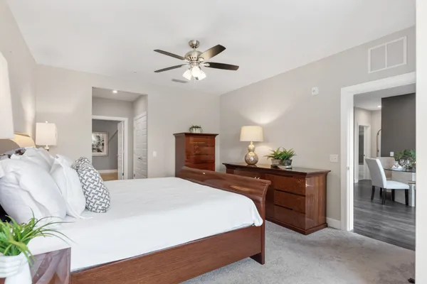 a bedroom with a bed and a chandelier