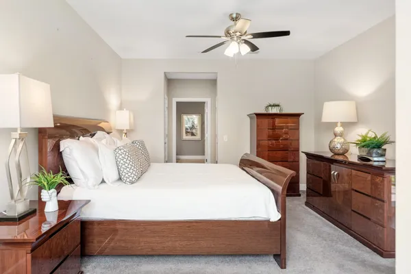 a bedroom with a large bed and a chandelier