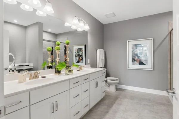a bathroom with a double vanity sink and a mirror