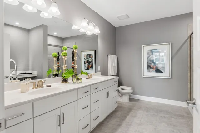 a bathroom with a double vanity sink and a mirror