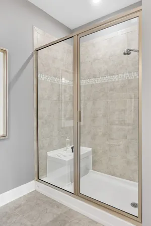 a bathroom with a glass shower door