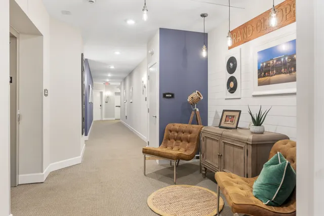 a living room with furniture and a bathroom