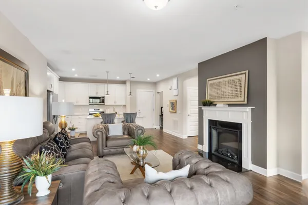 a living room with furniture fireplace and kitchen view