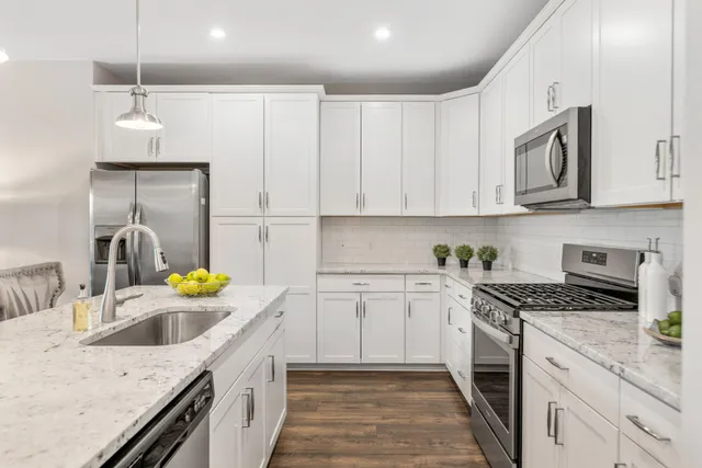 a kitchen with a sink stove and cabinets