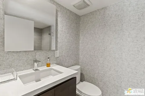 a bed room with a bed and a ceiling fan