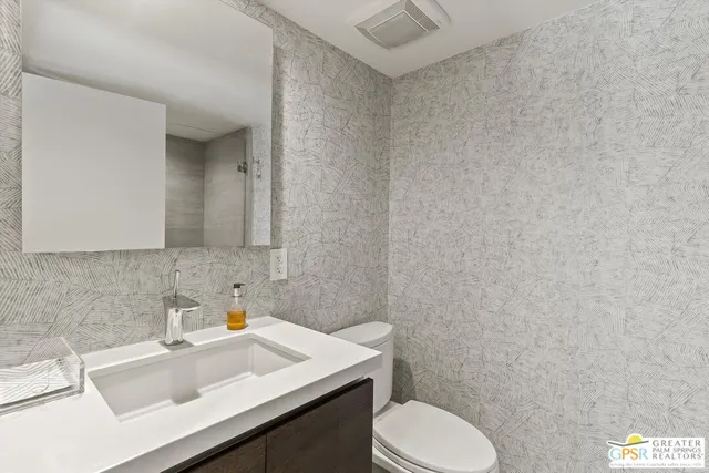 a bed room with a bed and a ceiling fan