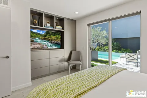 a bedroom with a bed and a painting on the wall