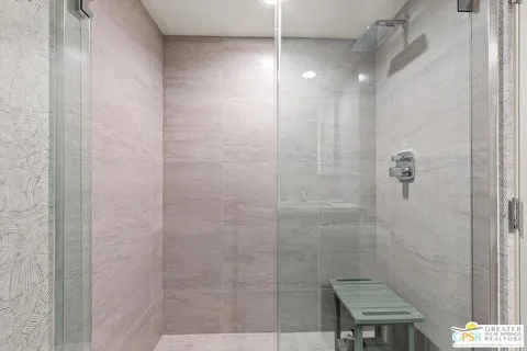 a bathroom with a double vanity sink toilet mirror and bathtub