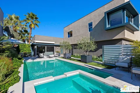 a house view with a seating space and garden