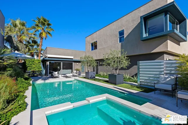a house view with a seating space and garden