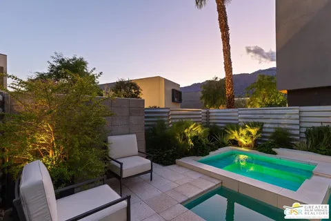 a view of a patio with table and chairs under an umbrella