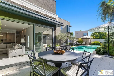 a view of a house with backyard and sitting area
