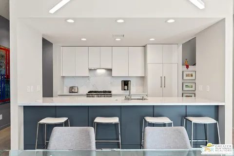 a kitchen with granite countertop a sink stove and cabinets