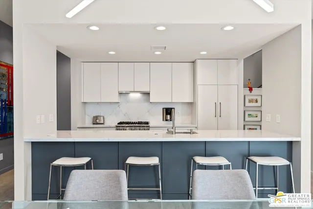 a kitchen with granite countertop a sink stove and cabinets