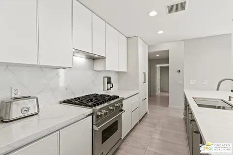 a kitchen with a sink stove and refrigerator