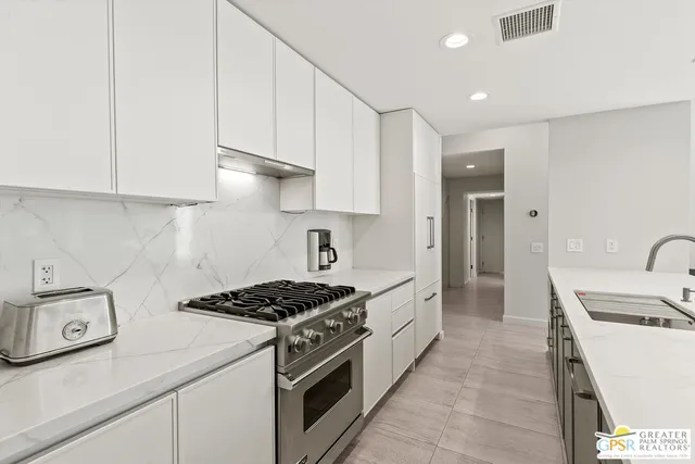 a kitchen with a sink stove and refrigerator