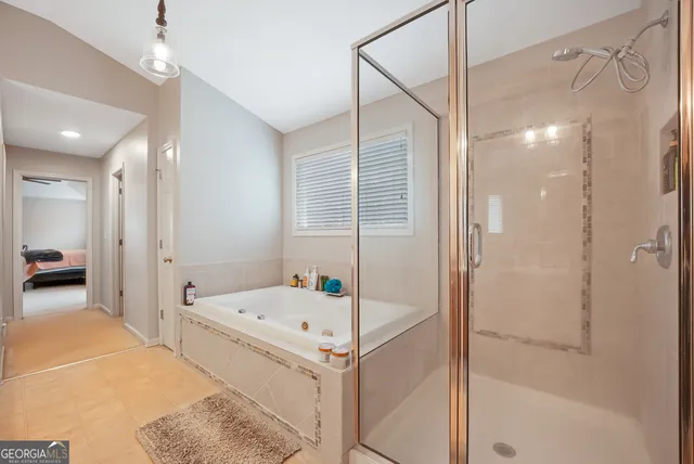 a bathroom with a tub and shower