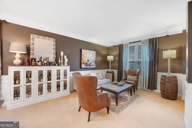 a living room with furniture and a floor to ceiling window