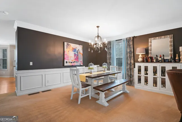 a living room with furniture a chandelier and a flat screen tv