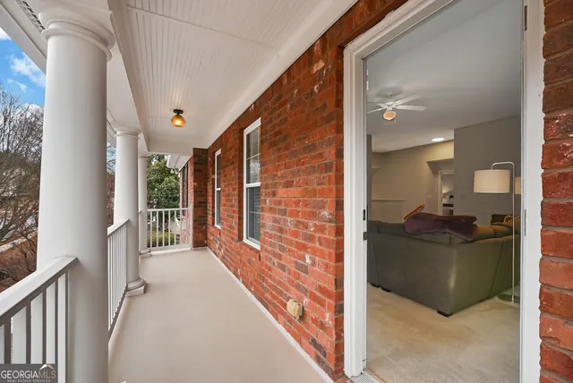 a bathroom with a granite countertop toilet a sink a mirror a window and a shower