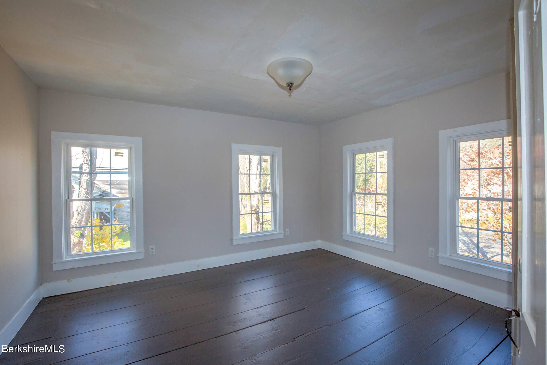 3 Sandisfield Road Sandisfield, MA 01255 - Photo 38 of 49 a view of an empty room with a window and wooden floor