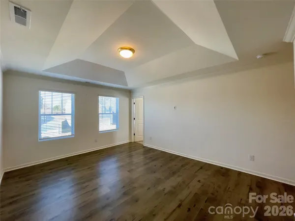 a spacious bathroom with a double vanity sink toilet mirror and shower