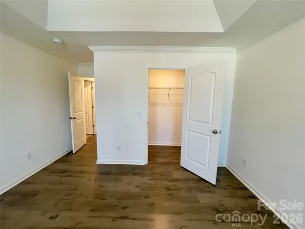 a view of a room with wooden floor and cabinet