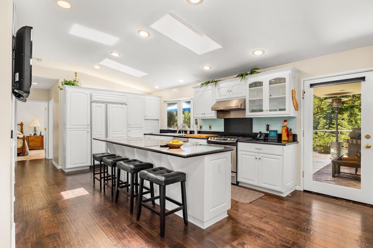 2000 Glen Canyon Road Santa Cruz, CA 95060 - Photo 9 of 41 a kitchen with stainless steel appliances kitchen island granite countertop a stove a sink dishwasher and a refrigerator with wooden floor