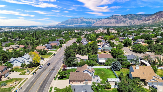 4792 Glasmann Way South Ogden, UT 84403 - Photo 17 of 70 Aerial perspective showcasing a residential area with custom home styles, mature landscaping, and mountainous terrain in the background