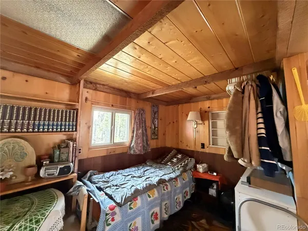 a bedroom with furniture and a window