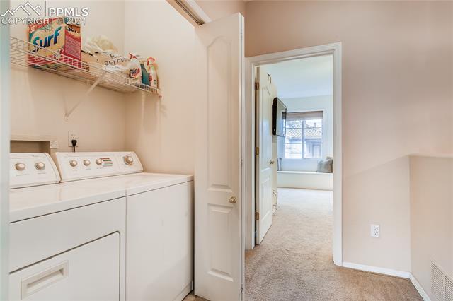 3207 Atrium Point Colorado Springs, CO 80906 - Photo 23 of 27 Washer and dryer conveniently located between bedrooms