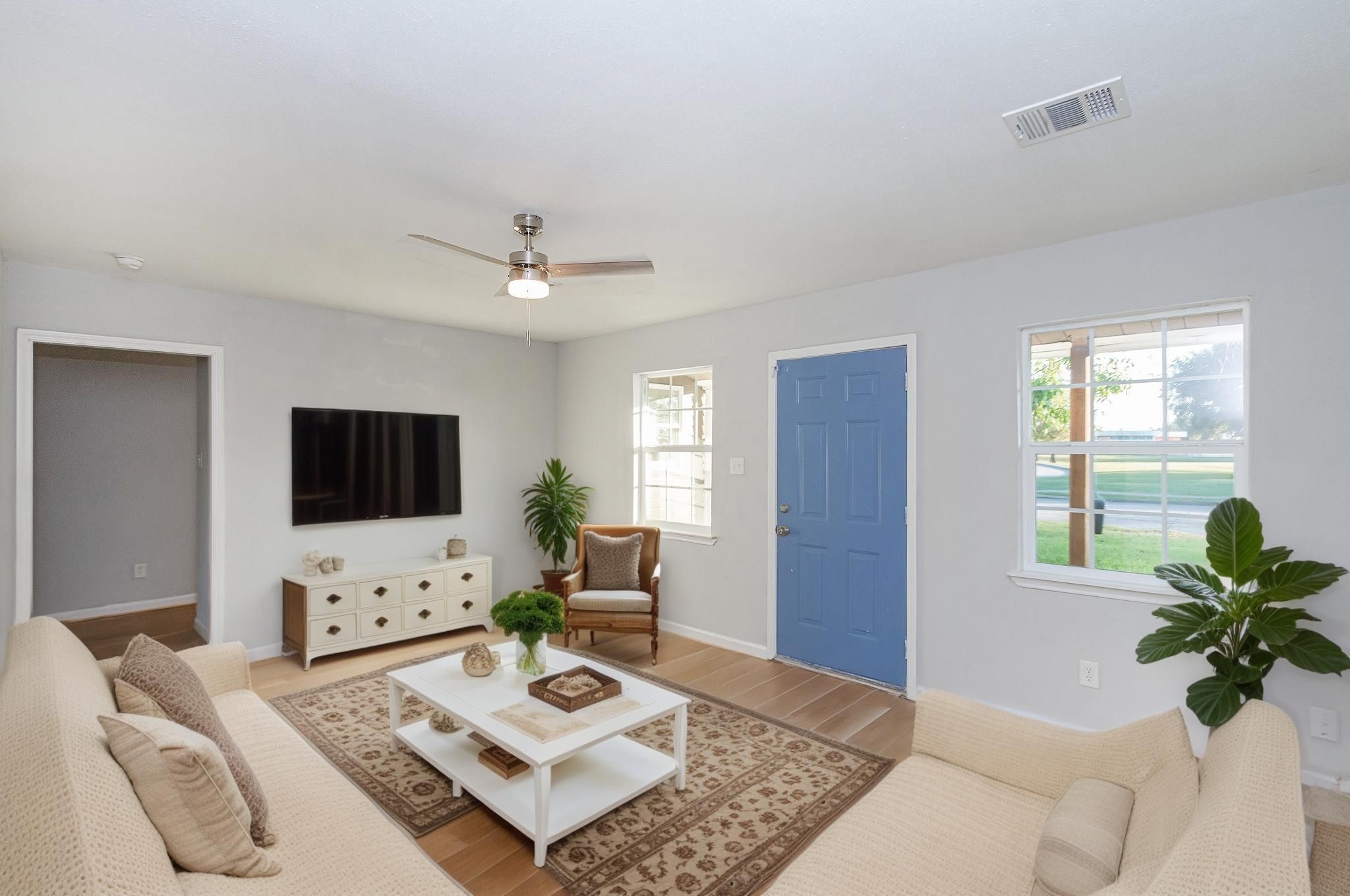 3707 Meadowlake Road Pasadena, TX 77503 - Photo 3 of 32 a living room with furniture a flat screen tv and a large window