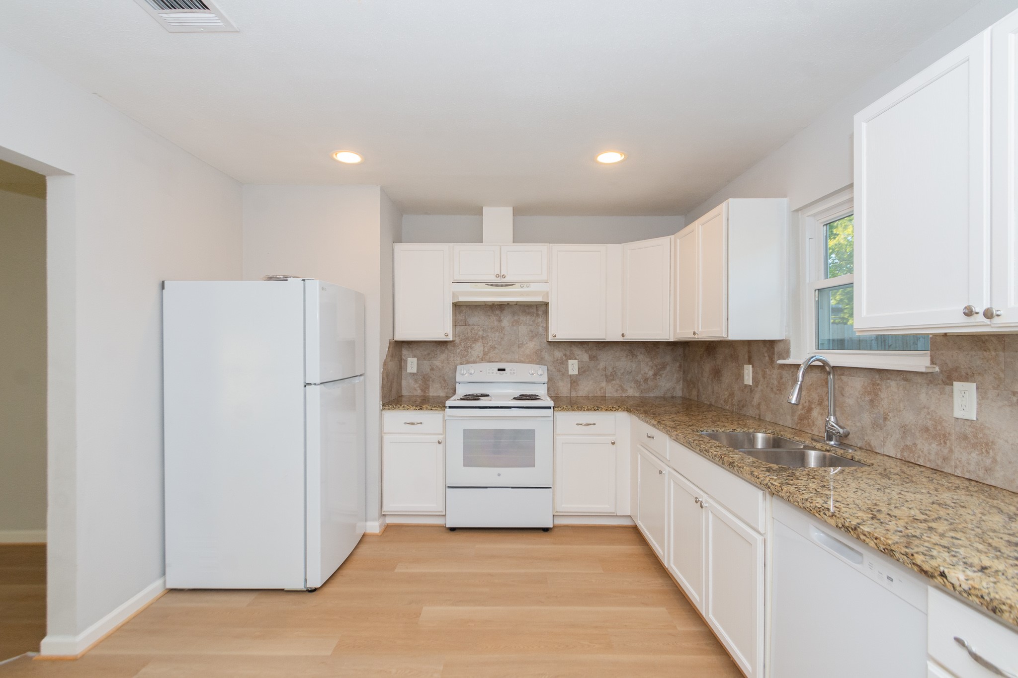 3707 Meadowlake Road Pasadena, TX 77503 - Photo 7 of 32 a kitchen with white cabinets and white appliances