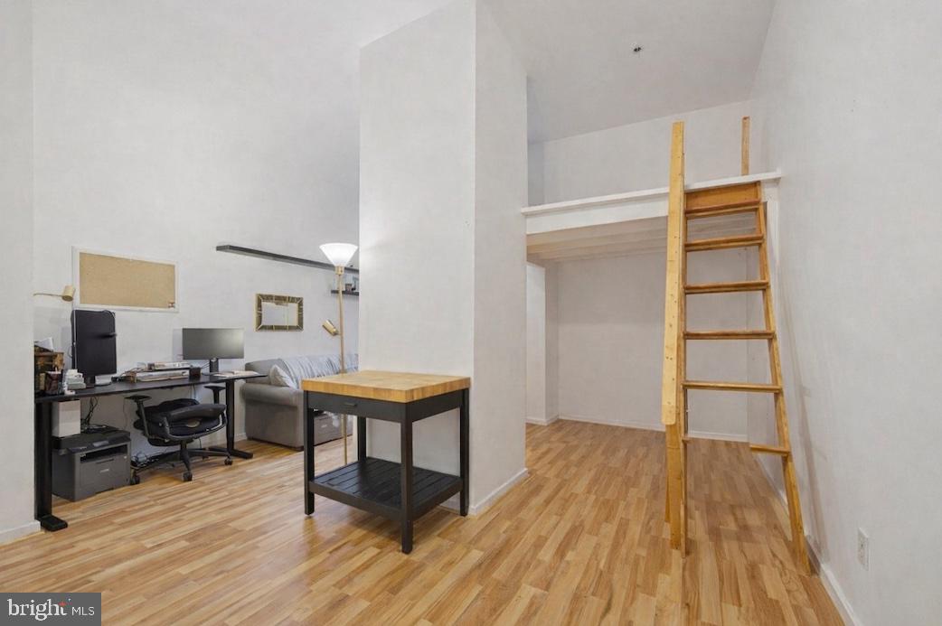 315 New Street, Unit 111 Philadelphia, PA 19106 - Photo 4 of 19 a workspace with wooden floor a cabinet and windows