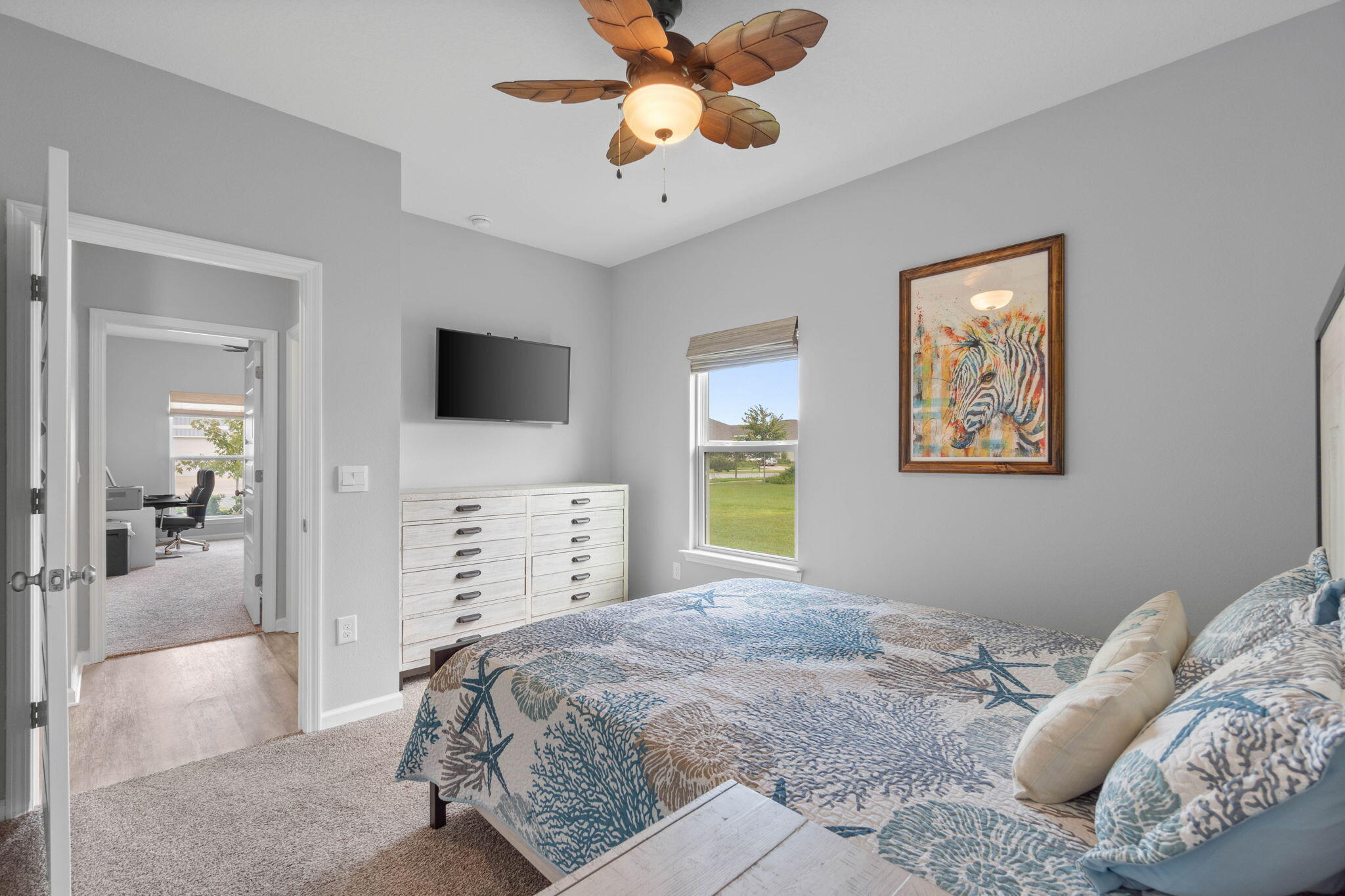 38 Silverthorn Street Freeport, FL 32439 - Photo 26 of 42 a bedroom with a large bed and a flat tv screen