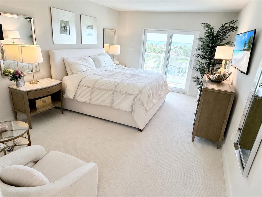 1050 Longboat Club Road, Unit 803 Longboat Key, FL 34228 - Photo 21 of 39 a bedroom with a bed and a couch