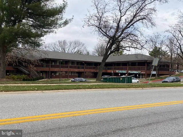 a view of a large building with a tree