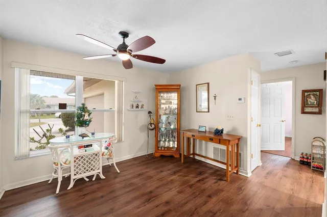 a dining room with furniture a chandelier and wooden floor
