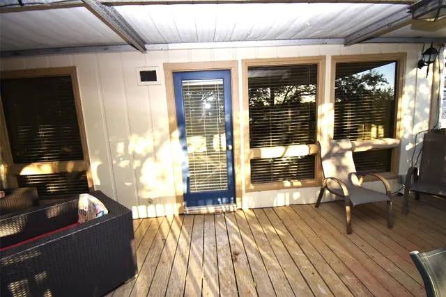 a view of a patio with wooden floor