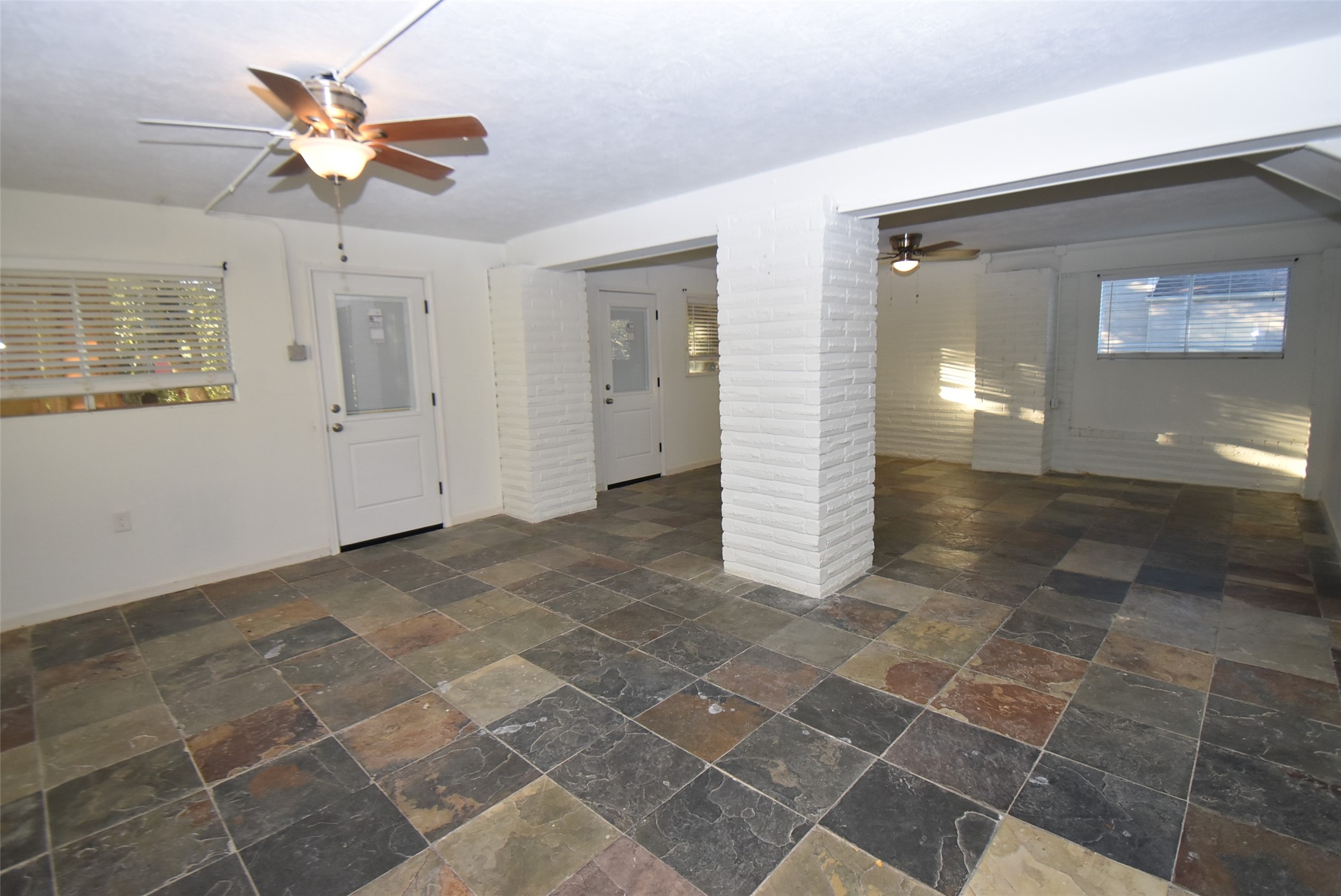 82 Harbor Lane Kemah, TX 77565 - Photo 31 of 33 a view of an empty room with a ceiling fan and window