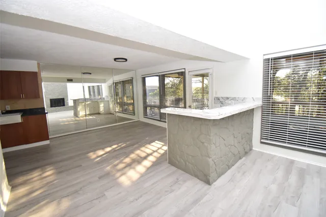 a living room with a couch and a view of kitchen appliances