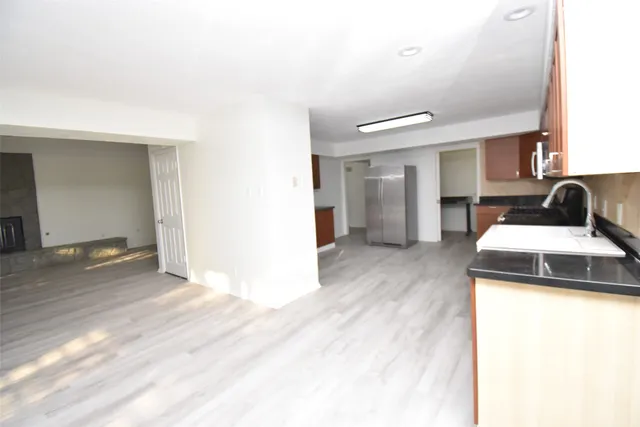 a kitchen with a sink and a refrigerator