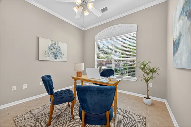 a dining room with furniture potted plants and wooden floor