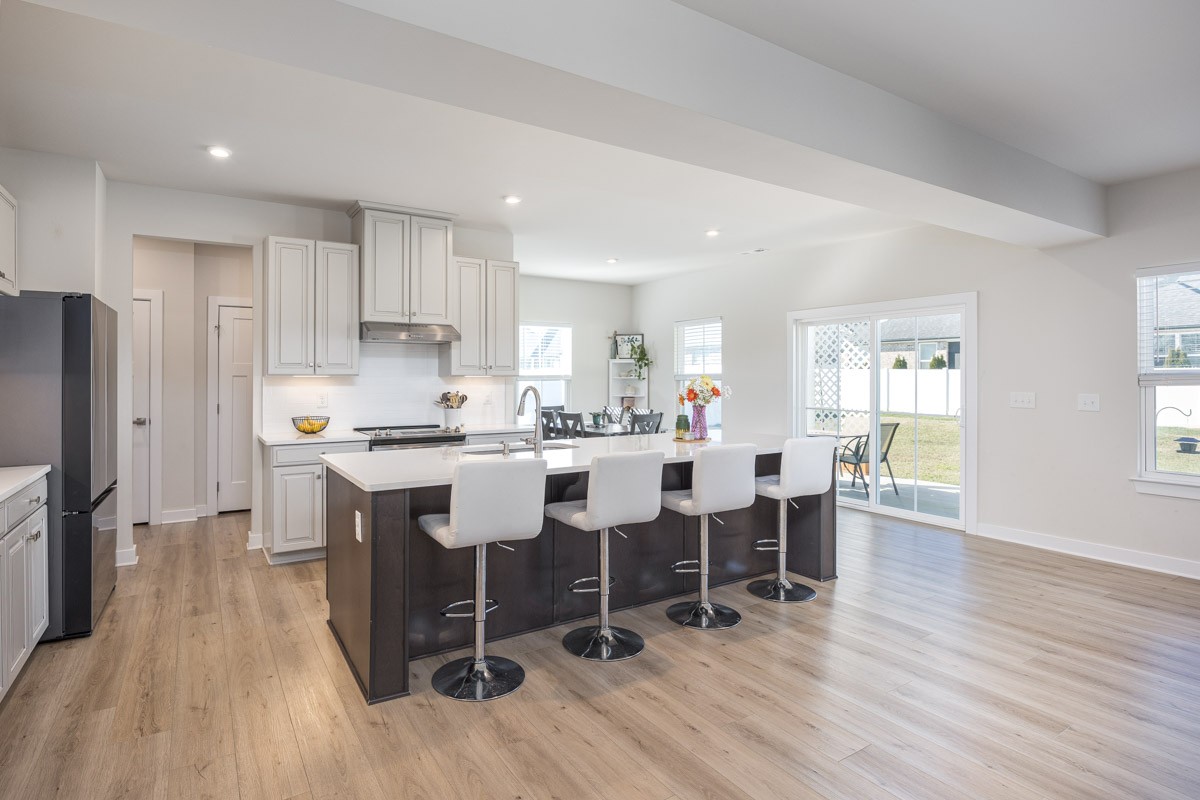 3232 Firerock Drive Murfreesboro, TN 37128 - Photo 15 of 45 a kitchen with stainless steel appliances kitchen island granite countertop wooden floors and white cabinets