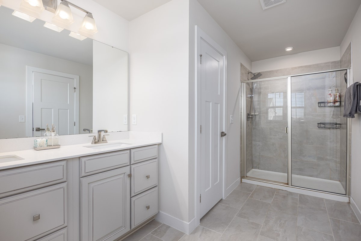 3232 Firerock Drive Murfreesboro, TN 37128 - Photo 26 of 45 a bathroom with a double vanity sink mirror and shower